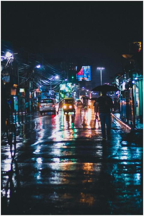 Vibrant night street in Kolkata with wet reflectio
