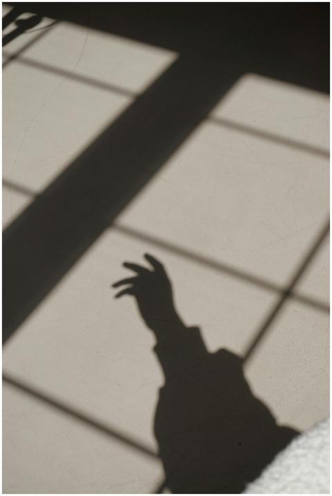 Intriguing shadow of a hand on a sunlit wall, crea