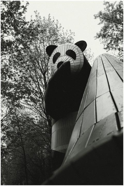 A towering panda statue amidst trees in a Moscow p