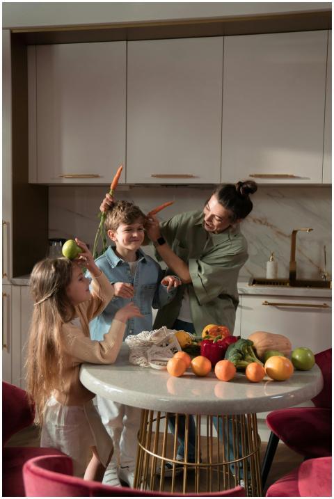 Mother and children having fun with fresh vegetabl