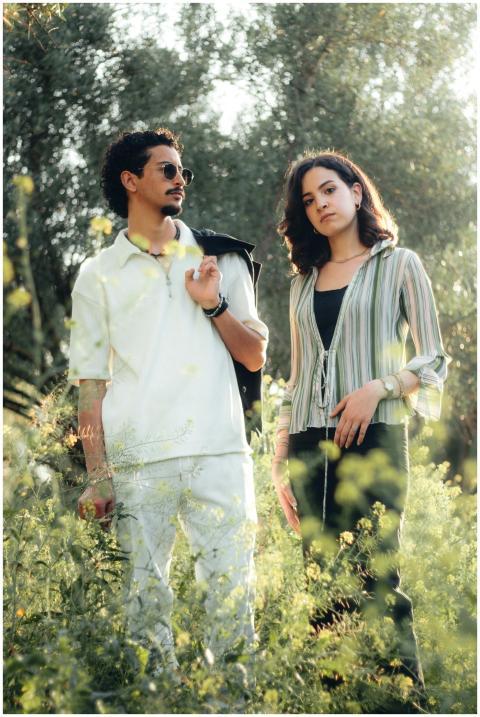 A fashionable young couple standing in a sunlit fi