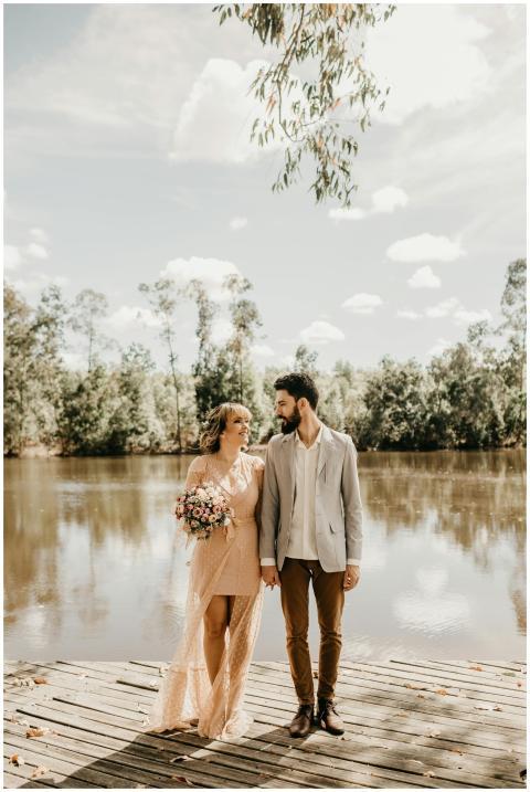 A couple enjoys a romantic moment by a serene lake