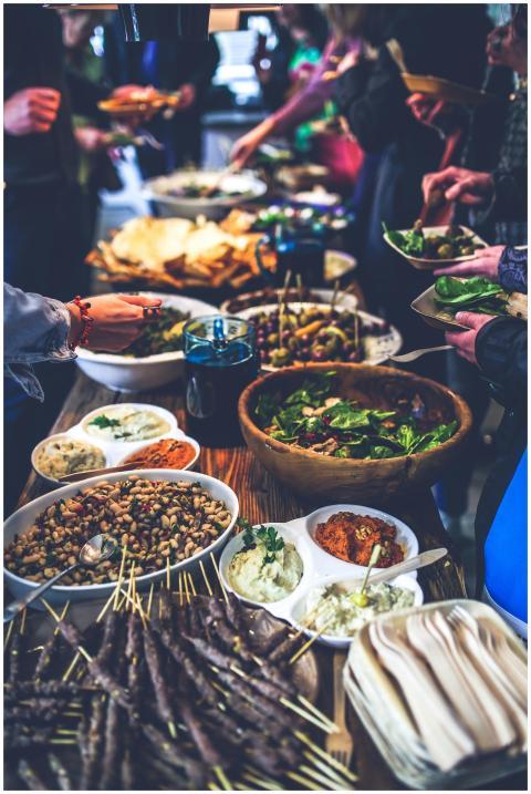 A vibrant buffet spread with salads, skewers, and