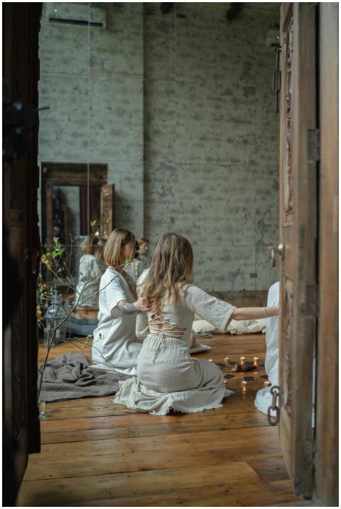 Group of women performing a candlelit spiritual se