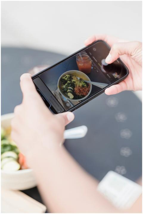 From above of crop unrecognizable blogger taking p