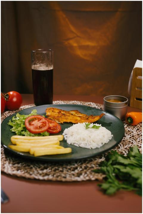 A vibrant Brazilian meal featuring fish, rice, sal