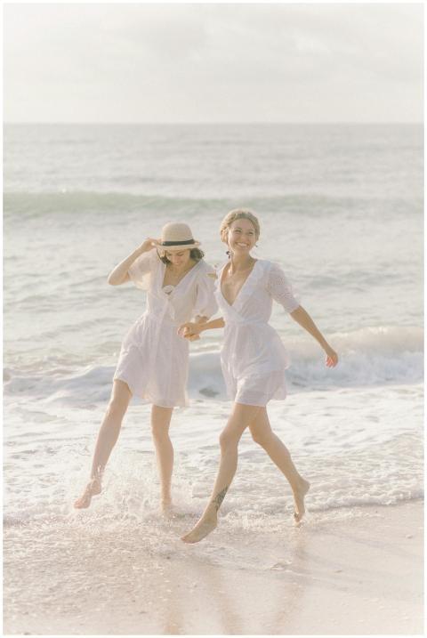 Two women in white dresses enjoying a sunny day on