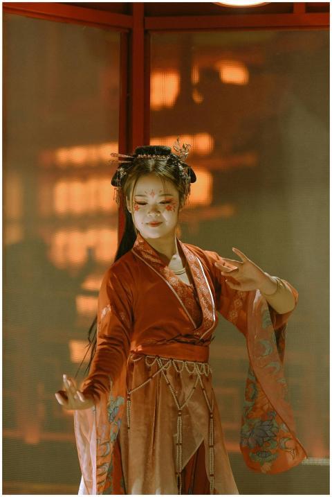 Woman in red traditional Chinese dress with face p
