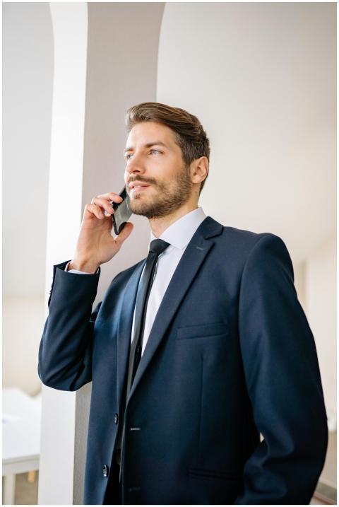 Confident businessman in a suit having a phone con