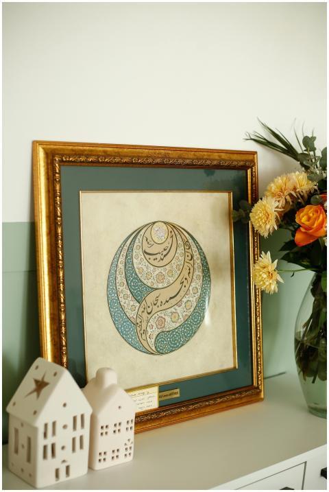 Beautiful calligraphy art framed in gold, adorned