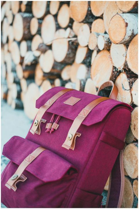 Close-up of a stylish pink backpack leaning agains