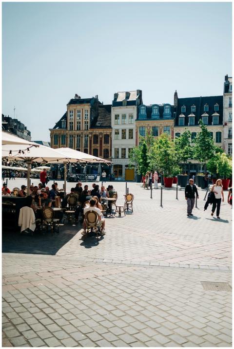 Sunny day in Lille's Old Town Square with people e