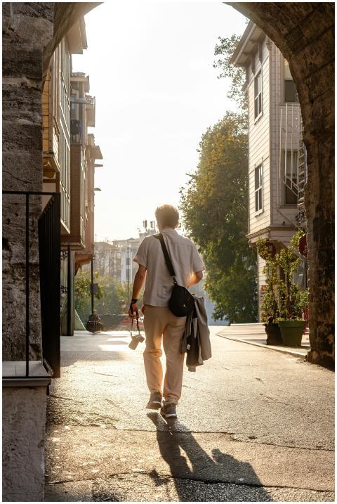 A person walking through an ancient archway in a s