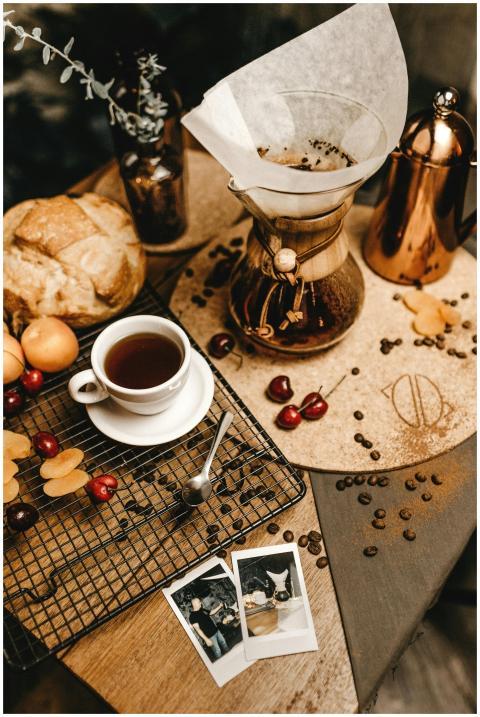 A cozy breakfast scene with coffee, bread, and che
