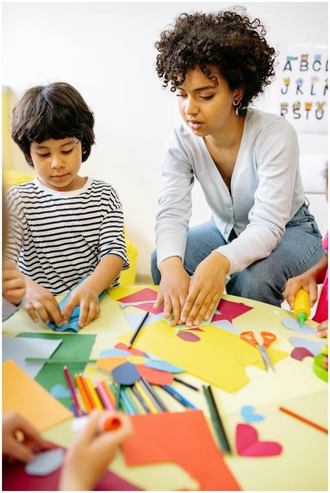 Children and teacher engaging in creative arts and