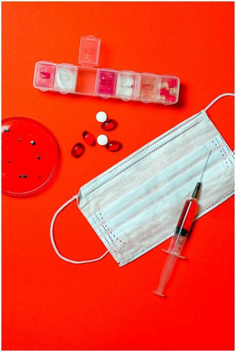 Flat lay of medical supplies including face mask,