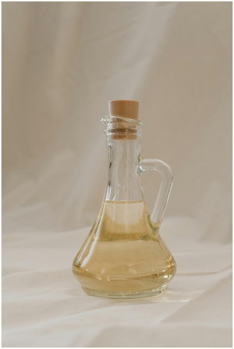 A stylish glass bottle filled with olive oil, show