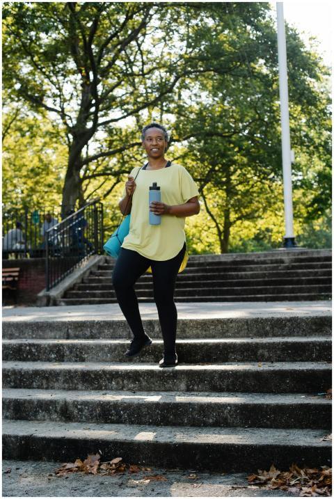 Elderly woman in active wear holding a water bottl