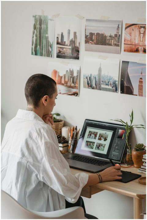 Focused woman editing photos on a laptop at a cozy