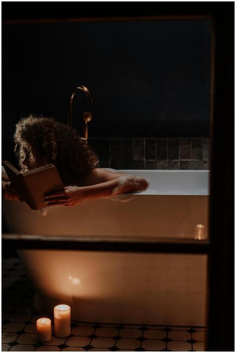 Woman with curly hair reading a book in a bubble b