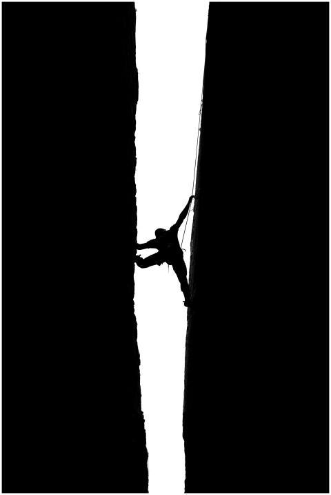 Dramatic silhouette of a climber scaling Pennadomo