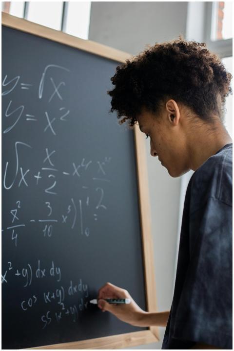 Side view of African American learner making math