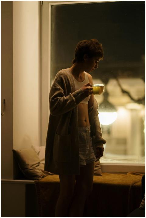 A relaxing night scene featuring a woman enjoying