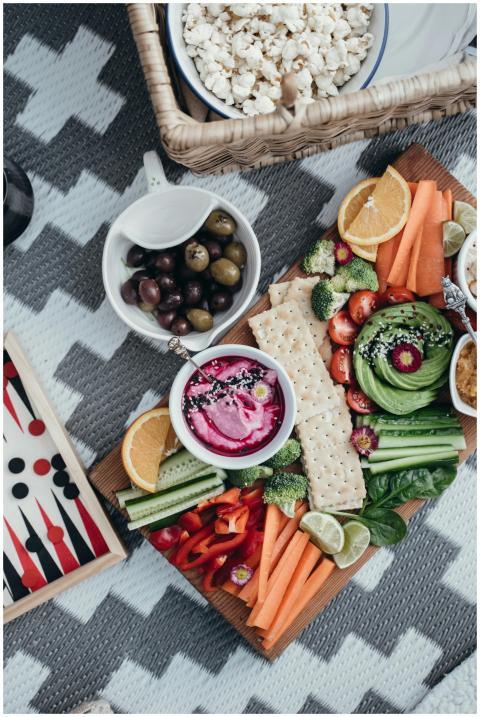 Colorful vegetable platter with dips and crackers,
