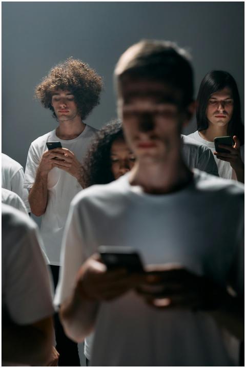 A diverse group of adults absorbed in their smartp