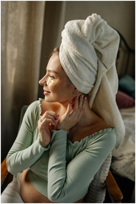 Pregnant woman relaxing at home with eye masks and