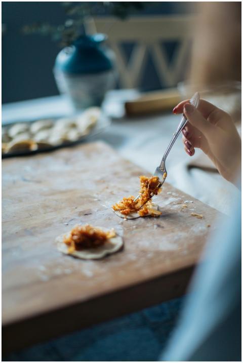 A close-up view of a hand preparing traditional du