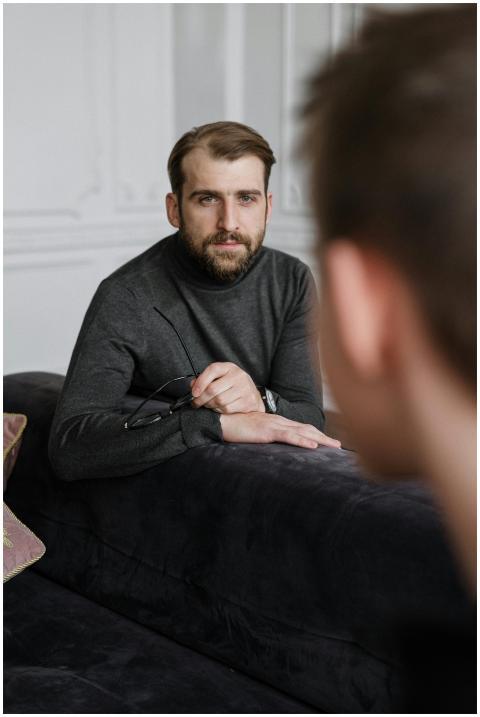 A thoughtful therapist listens attentively to a pa