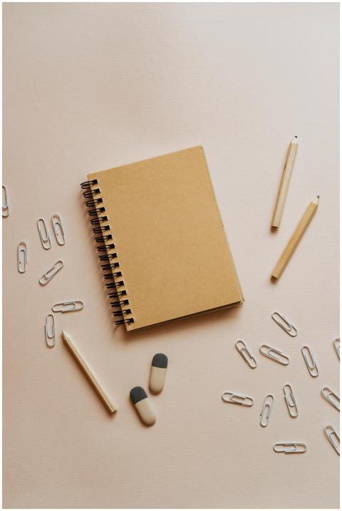 A minimalist flat lay featuring a spiral notebook,