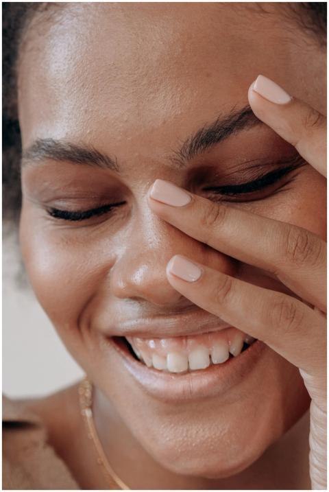 Warm close-up portrait of a black woman laughing j