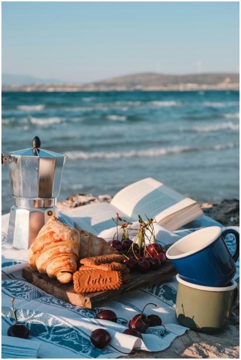 Relaxing beach picnic with coffee, croissants, and