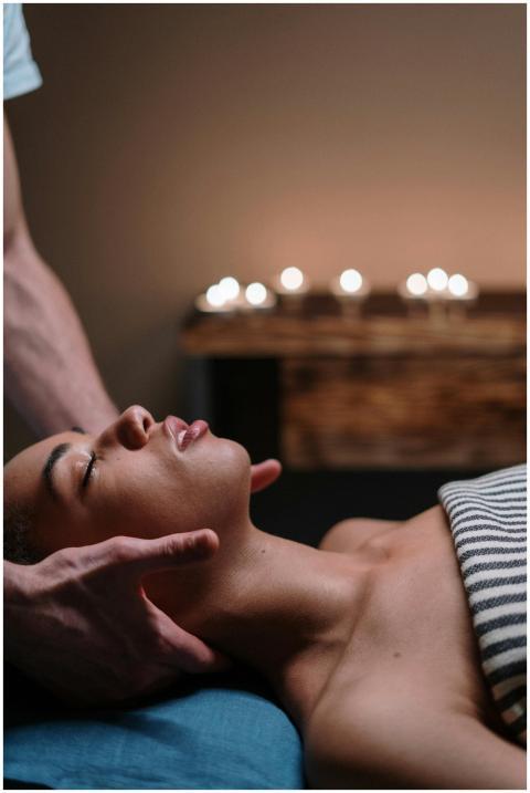 A woman enjoying a relaxing face massage in a tran