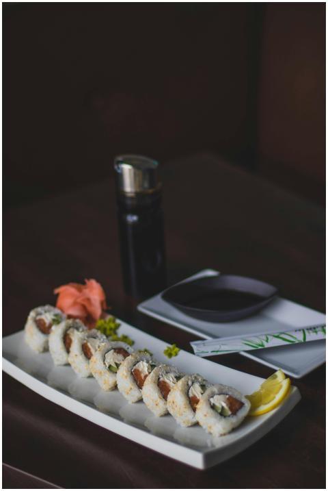 Tasty sushi rolls served with soy sauce, ginger, a