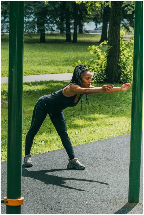 Woman performing a stretching exercise outdoors in
