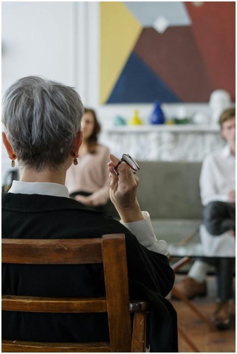 A therapist leads a couple's therapy session in a