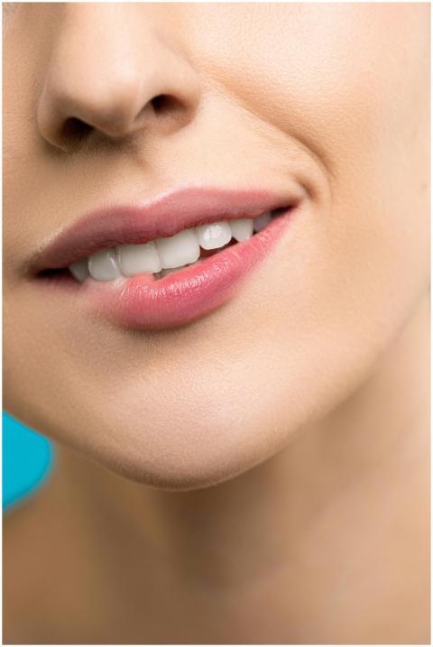 A detailed close-up of a woman's smile highlightin