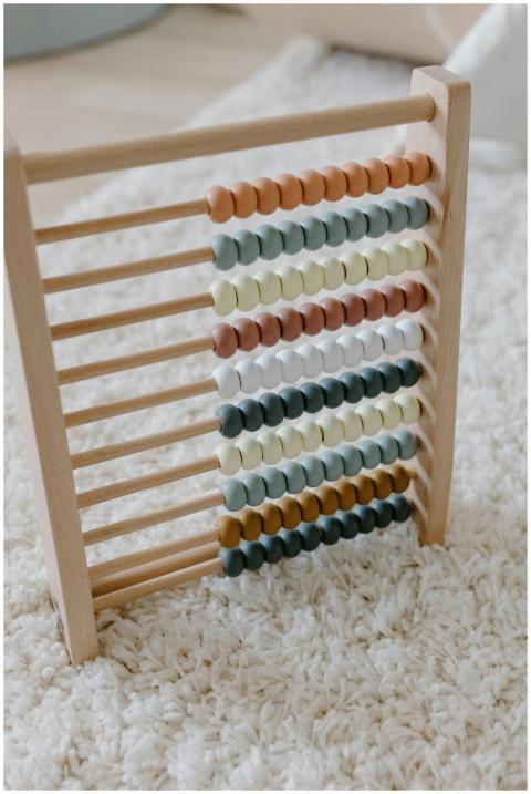 Colorful wooden abacus set against a soft carpet,