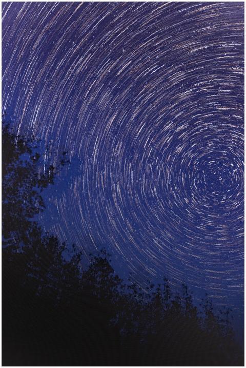 Captivating star trails spiral in a clear night sk