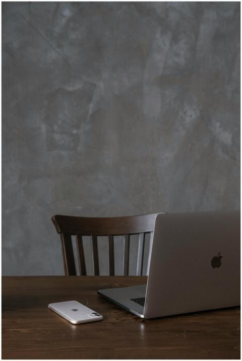 A modern minimalist workspace featuring a laptop a