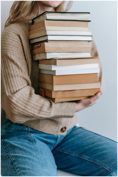 Crop unrecognizable female student in casual cloth