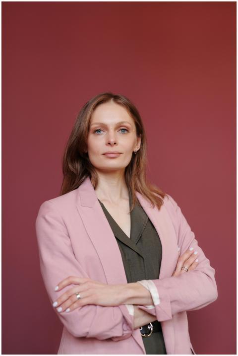 Elegant businesswoman with arms crossed in studio