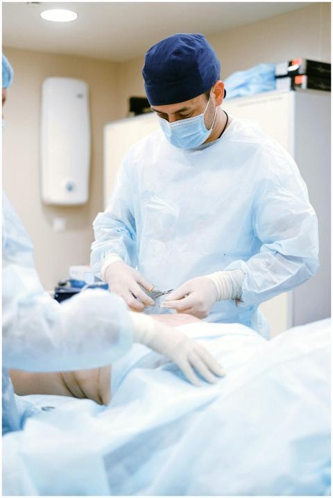 Doctors in protective gear performing surgery in a