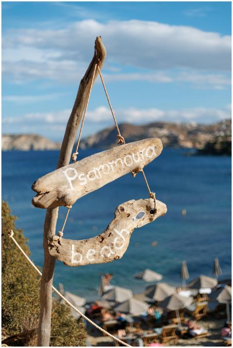 A rustic wooden sign marks Psaromoura Beach, a pic