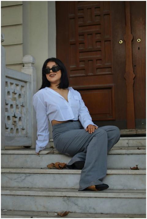 Stylish woman in sunglasses posed casually on eleg