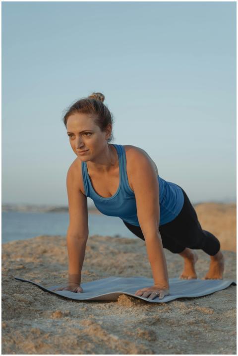 Focused woman practicing a plank position on a yog
