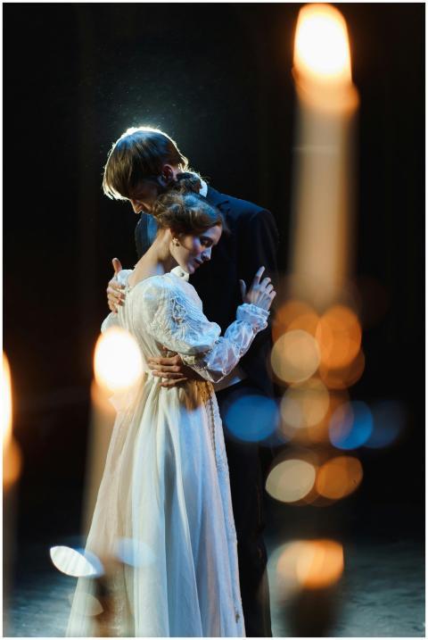 A romantic scene featuring a couple embracing on s